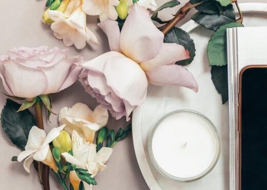 Flowers, notebook and phone on desk