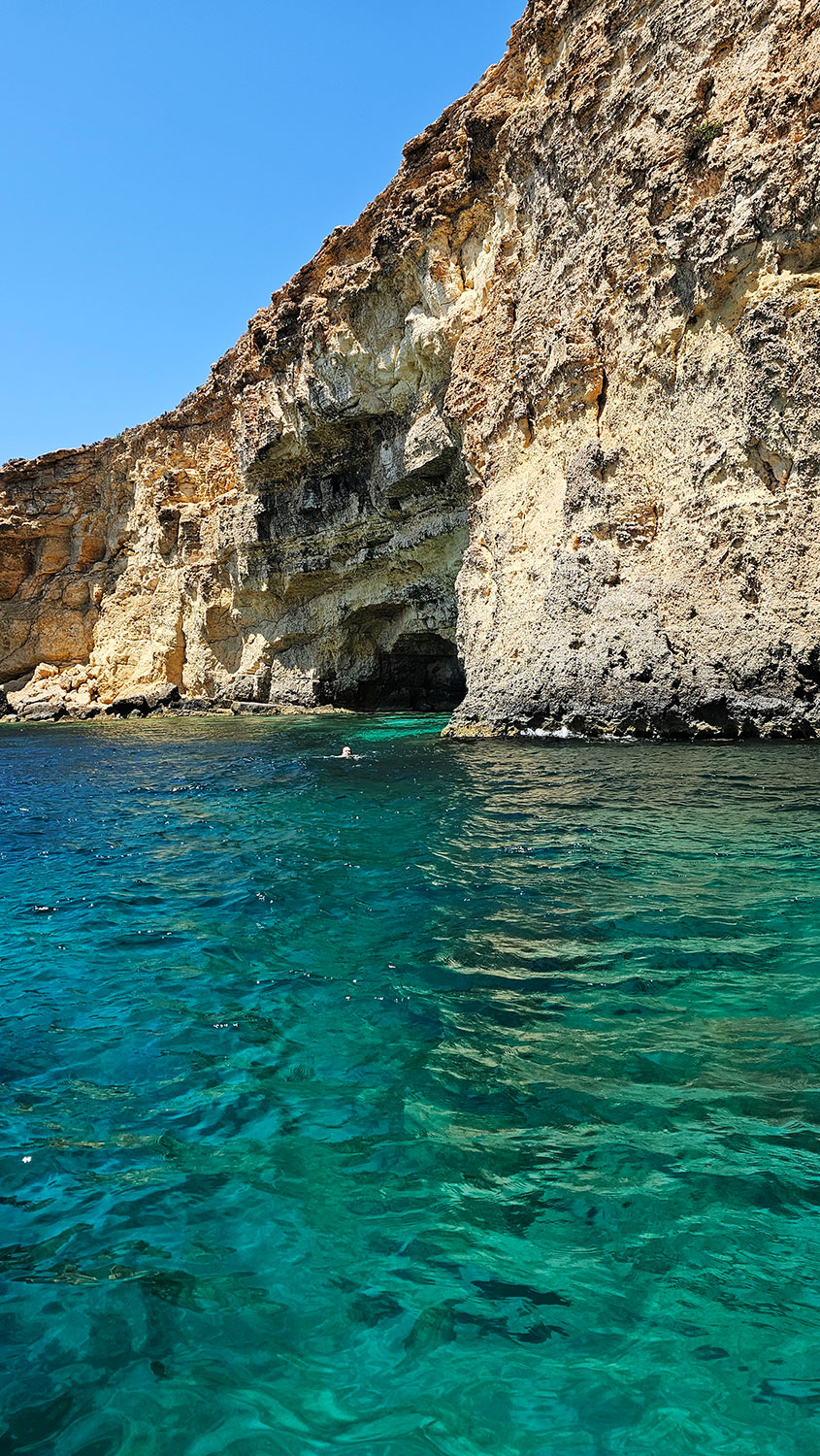 Blue-green water and cave